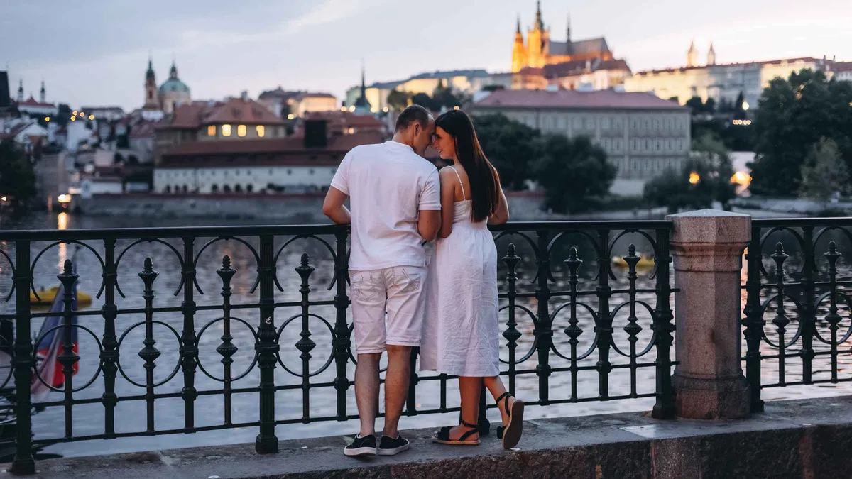 A photographer framing visitors in front of St Vitus Cathedral during a Prague Castle photoshoot, Prague